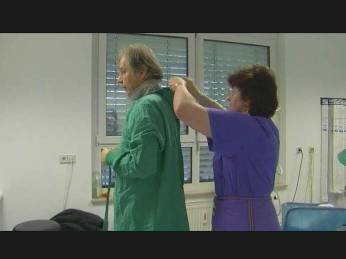 Arzt zieht OP-Kittel an ©Moritz Frisch